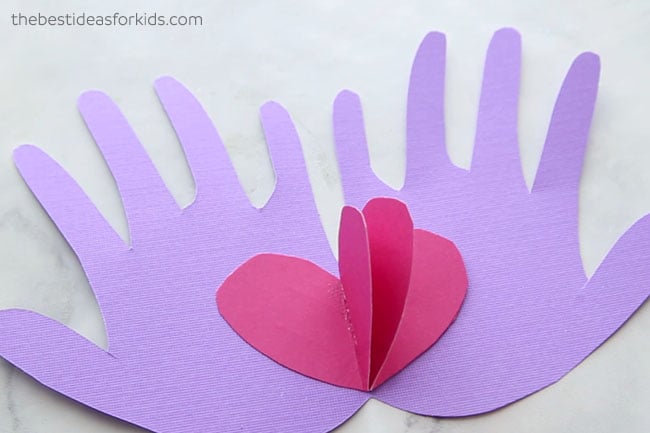 Glue Hearts to Handprint Valentine