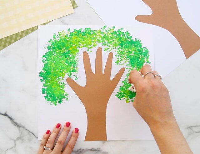 Painting first leaves onto tree