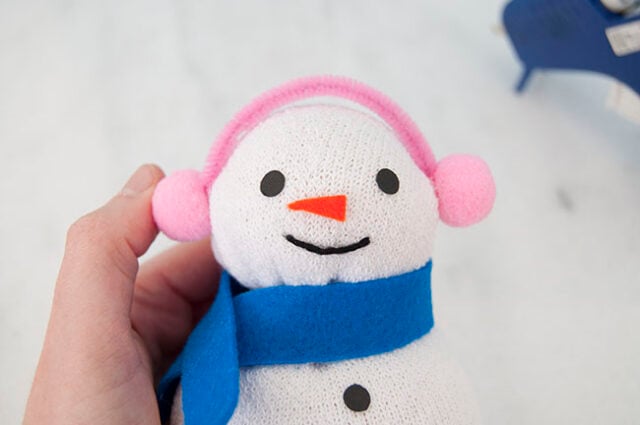 Pom pom earmuffs on snowman