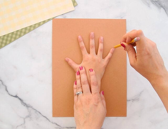 Tracing hand on brown paper